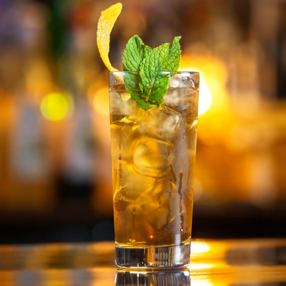 Chai and green tea mocktail with Chai Spices Spice Drops, garnished with mint and lemon.