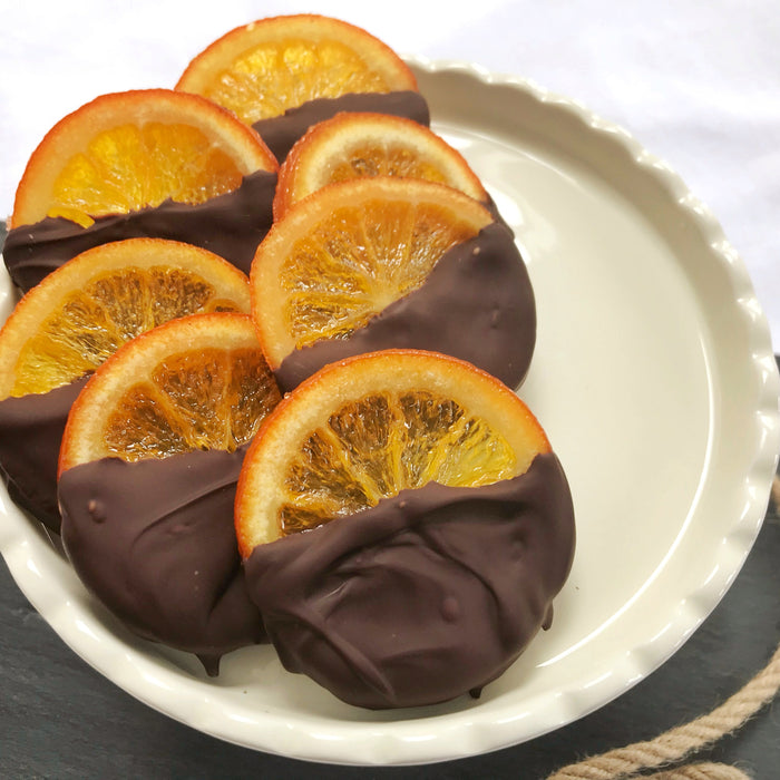 Chocolate dipped glace orange slices made with Orange Zest Spice Drops