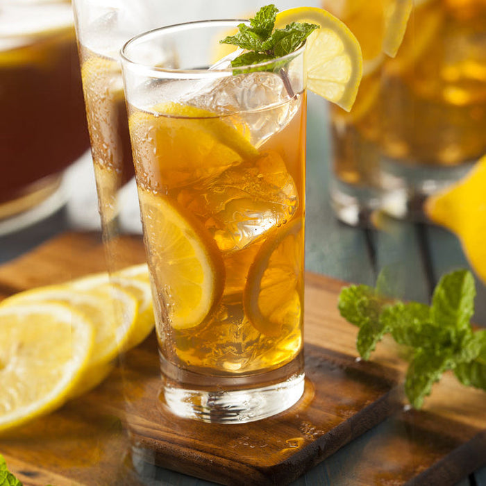 Iced mint tea made with Mint and Peppermint Spice Drops, garnished with lime and mint.
