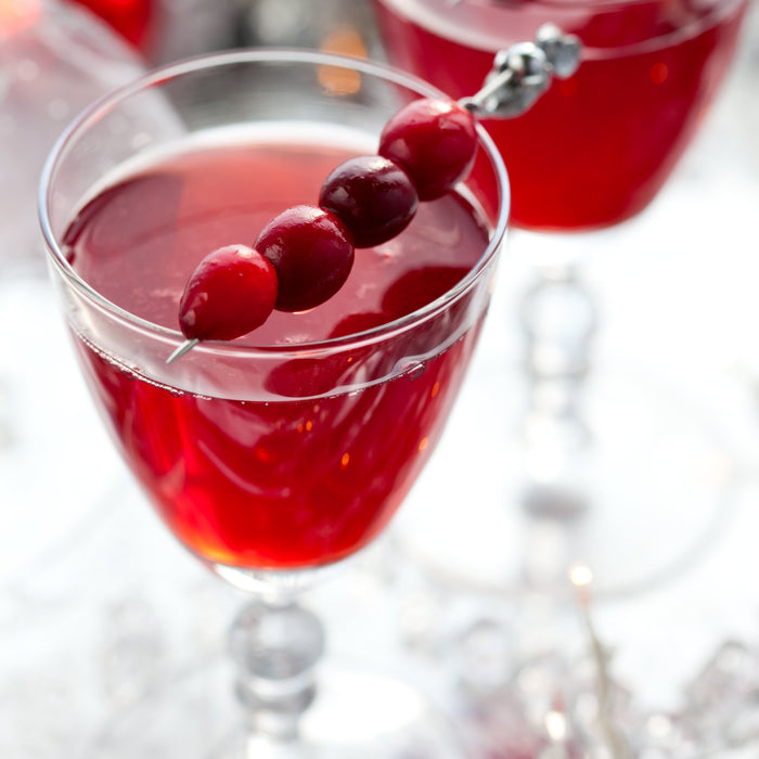 Red Rudolf cocktail with whipped cream and sugar sprinkles