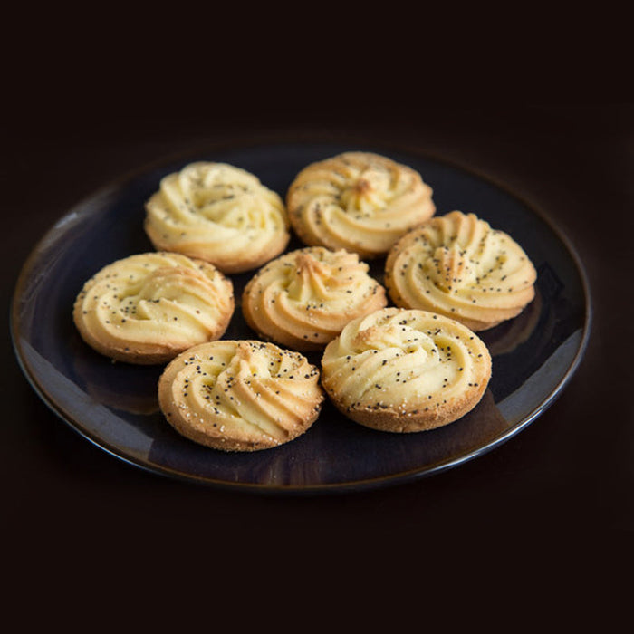 Rose and Cardamom biscuits piped into spirals, flavoured with Rose and Cardamom Spice Drops