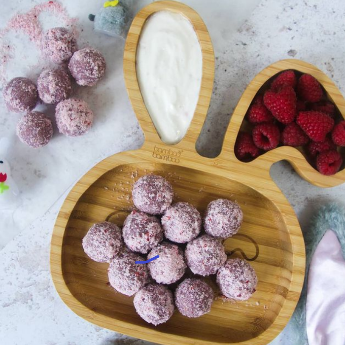 Raspberry and coconut bliss balls made with Vanilla Spice Drops, coated in desiccated coconut.