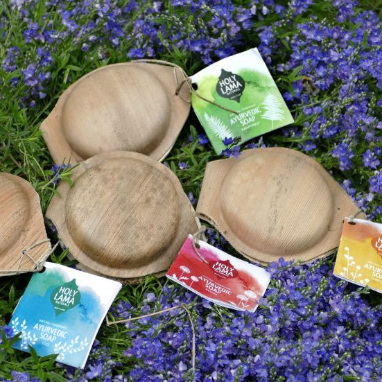 Holy Lama Ayurvedic soaps displayed outdoors in their palm leaf shells