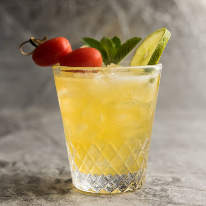 Tomato mojito garnished with mint leaves and grape tomatoes.