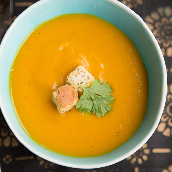 Carrot and cumin soup made with Cumin Seed and Ginger Spice Drops, swirled with yogurt.