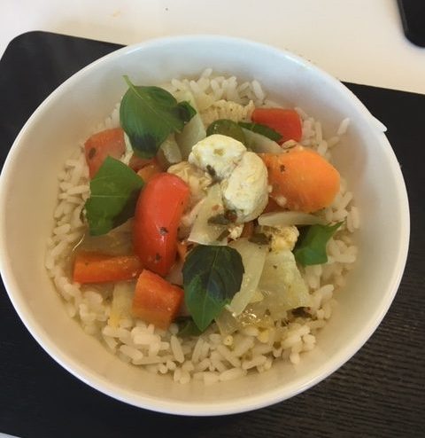 Thai green curry with coconut milk and vegetables, served over rice.