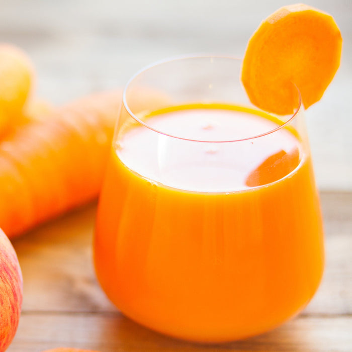 Glass of apple and carrot juice made with cinnamon and ginger Spice Drops