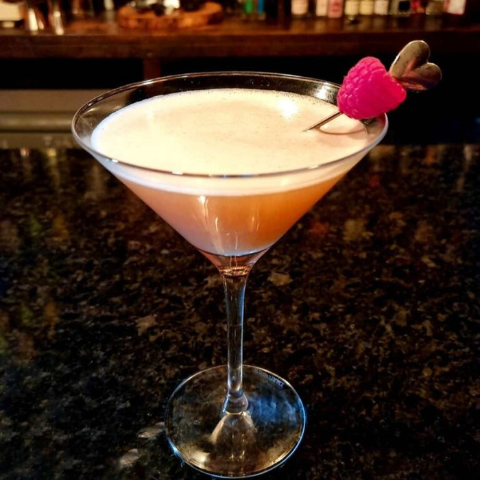 108 Sour cocktail in a coupe glass, made with Ginger and Orange Zest Spice Drops.